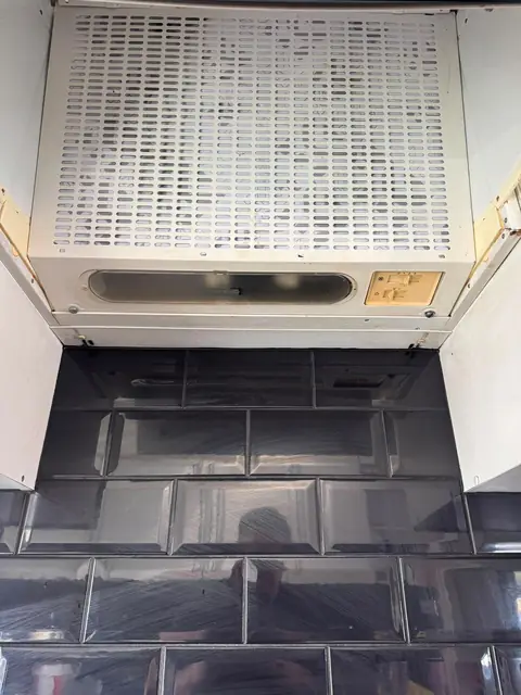 Greasy extractor hood filter after an Eco Oven Cleaning clean