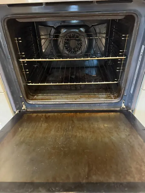 Built-in oven with glass door before cleaning