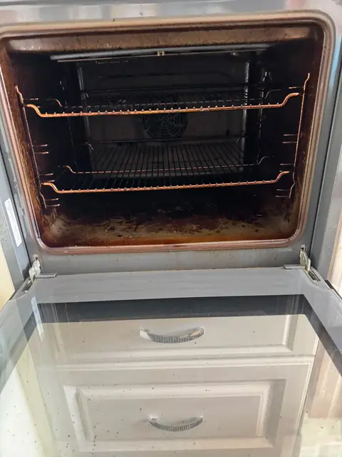 Built-in oven above a drawer before cleaning